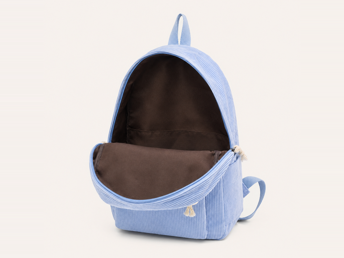 Intérieur du sac à dos en velours côtelé, compartiment doublé en toile avec sa poche